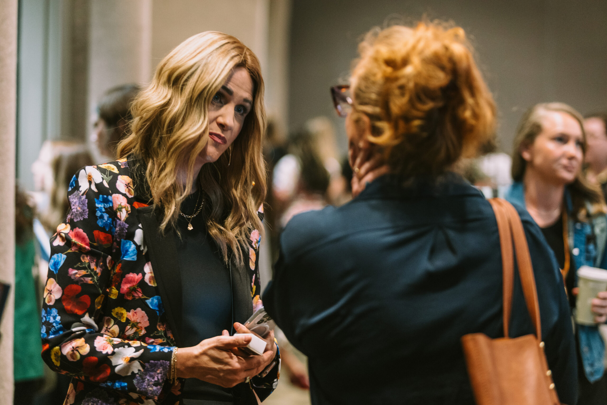 Barb Betts listening attentively during a networking conversation, demonstrating how to build trust faster through active listening and authentic relationships.