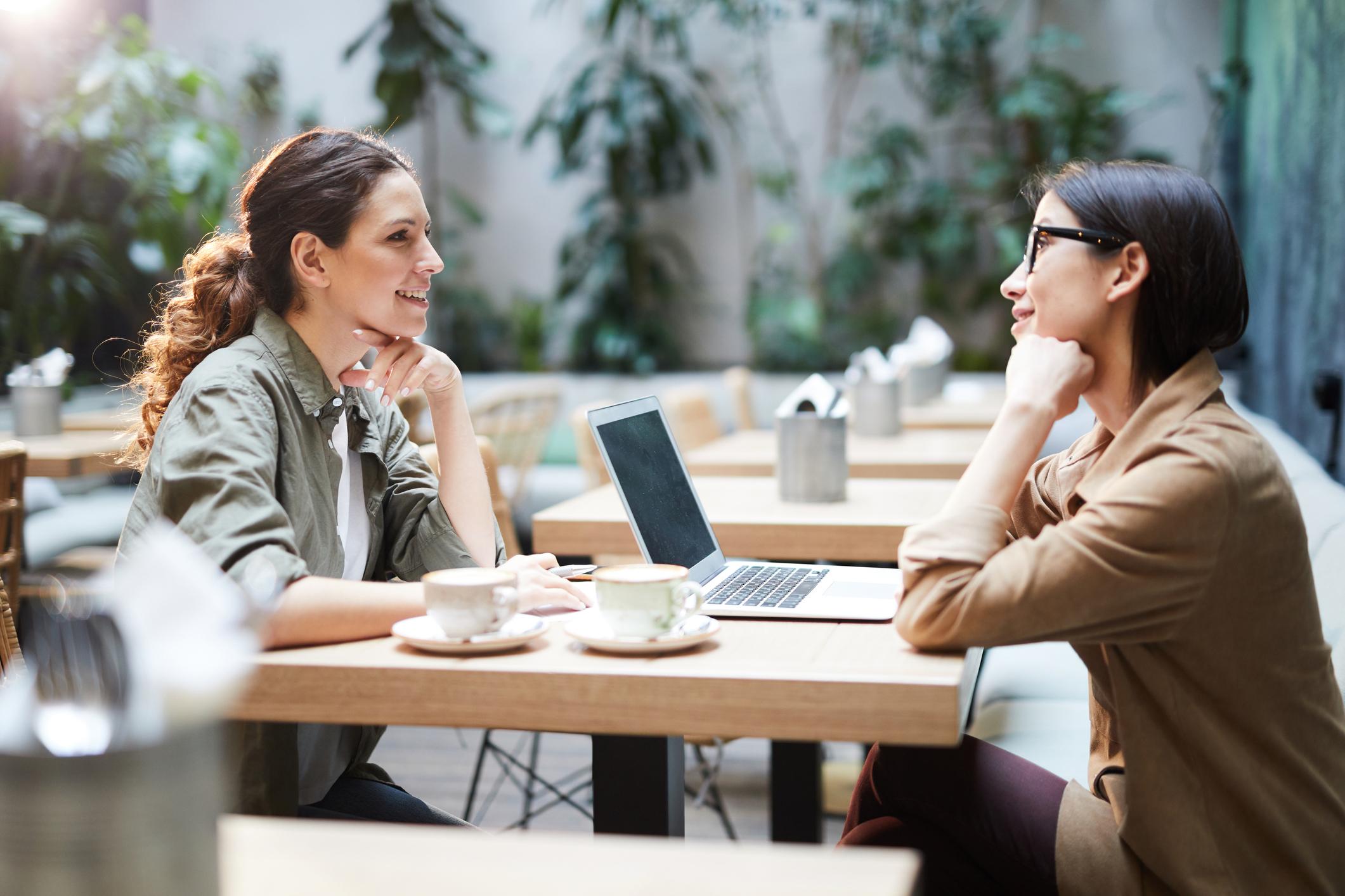 Communication vs connection in business: two professionals having a meaningful face-to-face conversation
